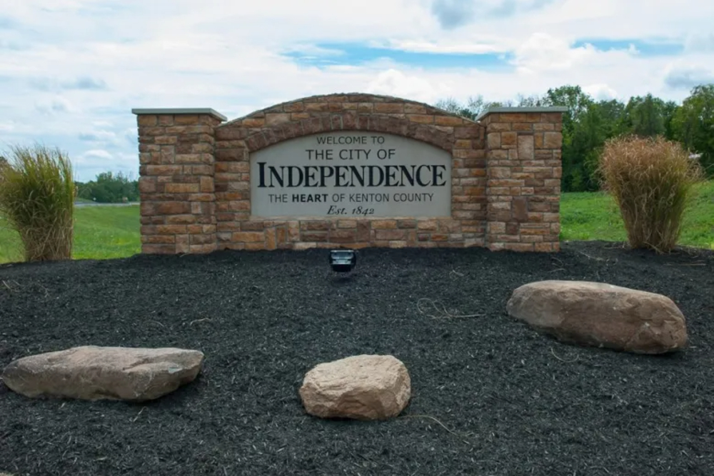Welcome sign for the City of Independence, Kenton County, with stone pillars and a landscaped foreground.